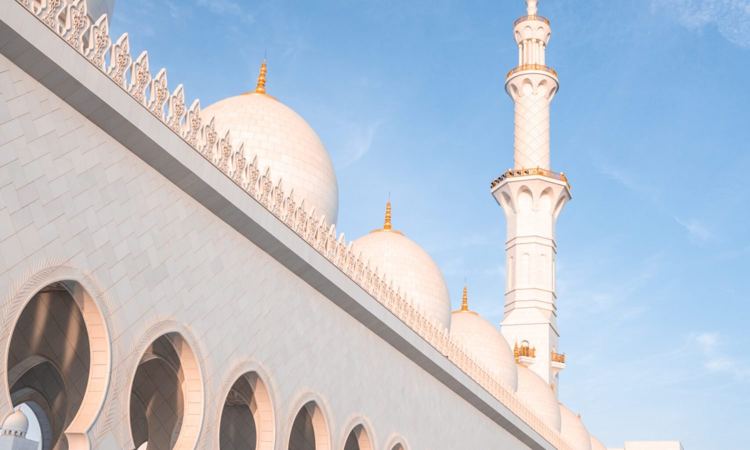 Sheikh Zayed Grand Mosque under the sunlight and a blue sky in Abu Dhabi, United Arab Emirates The Sheikh Zayed Grand Mosque under the sunlight and a blue sky in Abu Dhabi, United Arab Emirates